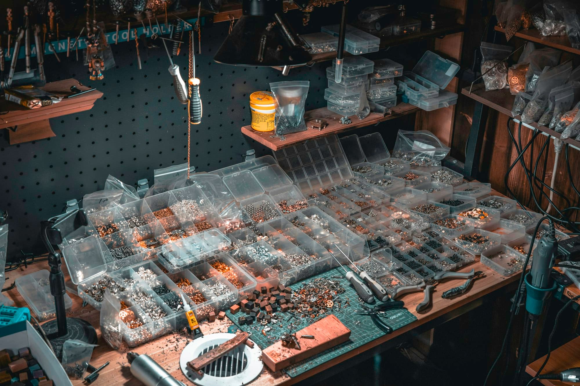 A small business workbench covered in parts and tools