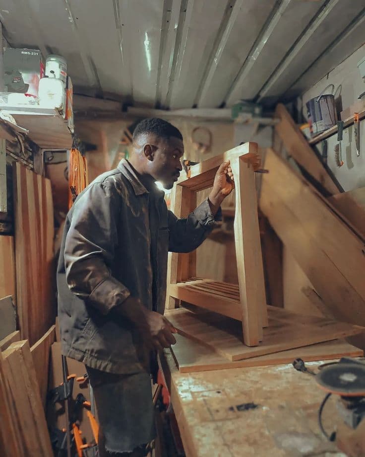 A carpenter working with tools in his workshop